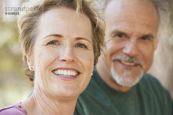 Senior Caucasian couple smiling outdoors
