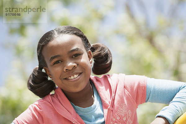 Mixed race girl smiling outdoors