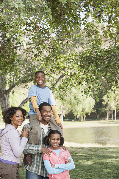 Family smiling together in park