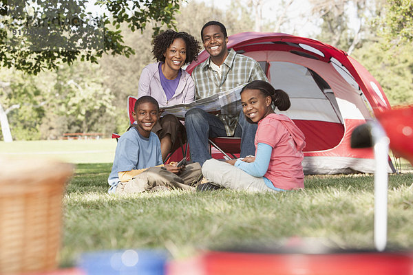 Family relaxing together at campsite