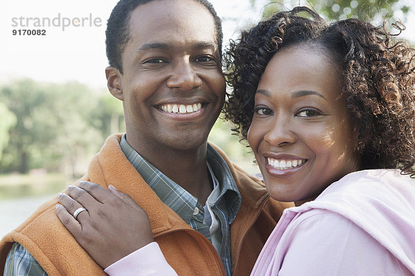 Smiling couple hugging outdoors