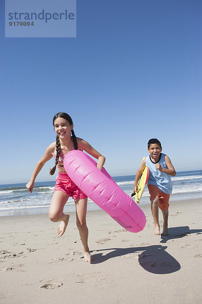 Hispanic children playing on beach