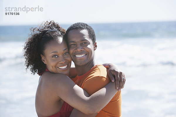 Couple hugging on beach