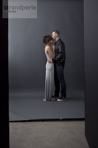 Couple kissing in studio