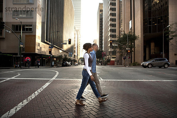 Couple crossing city street