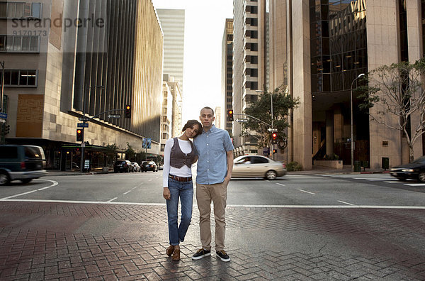 Couple standing on city street