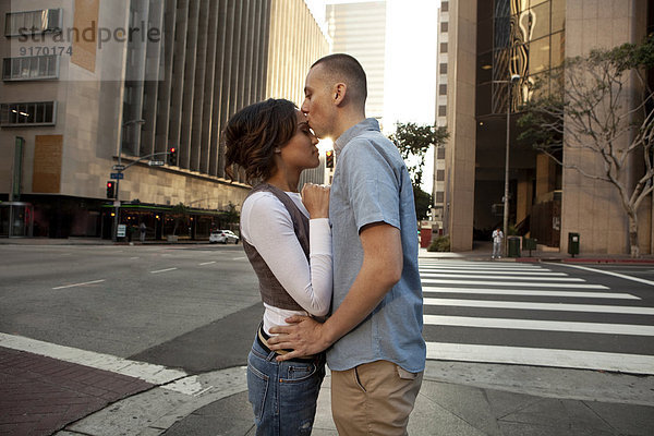 Couple kissing on city street