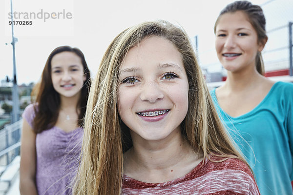 Teenage girls smiling on bleachers