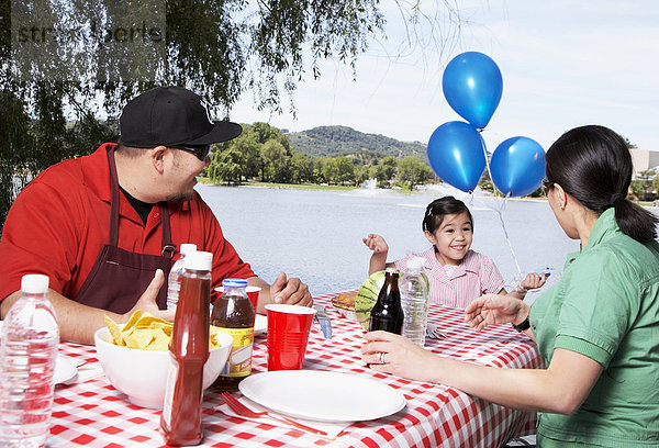 Family eating together at picnic