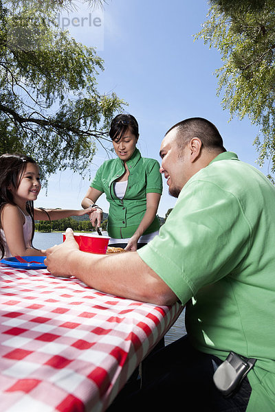 Family eating together at picnic