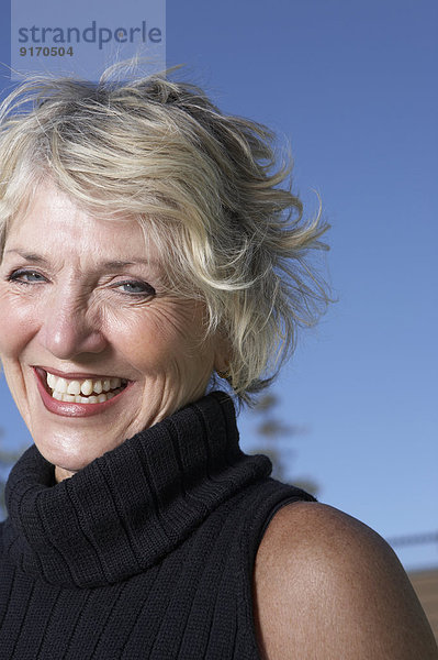 Senior Caucasian woman smiling outdoors