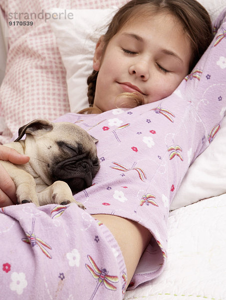 Mixed race girl sleeping with pug