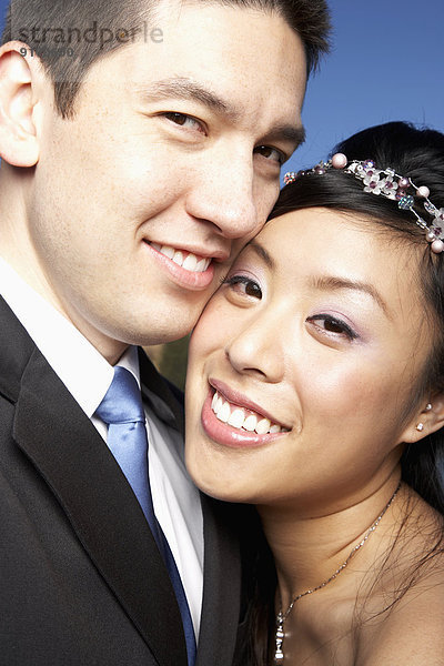 Newlywed couple posing outdoors