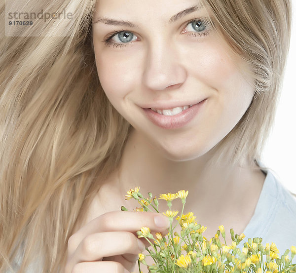 Smiling woman holding bouquet of flowers