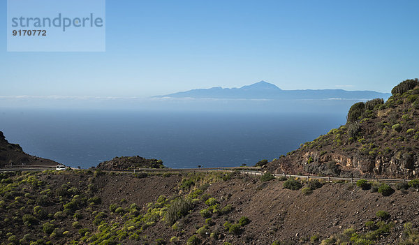 Spain  Canary Islands  Gran Canaria  Coastal road  Teneriffe in background