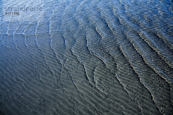 Wave pattern on sandy soil and waves