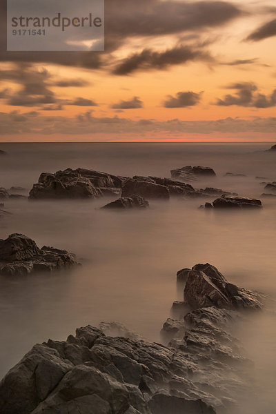 Australia  New South Wales  Tweed Shire  break of dawn at the rocky shore of Hastings Point