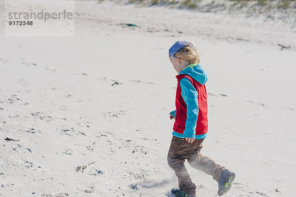 Germany  Mecklenburg-Western Pomerania  Ruegen  Schaabe  Boy walking on windy beach