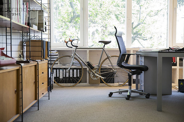 Racing cycle standing at workplace of modern office