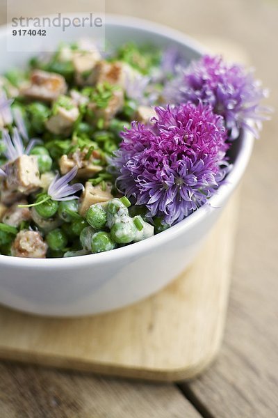 Creamy pea salad with spicy tofu pieces  soy yogurt  chives and mint