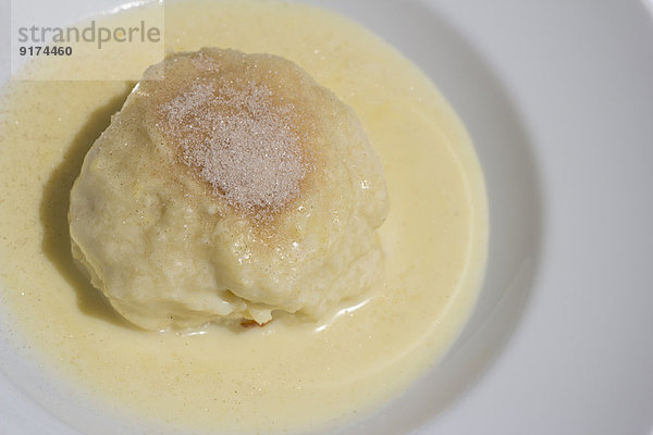 Yeast dumpling and vanille sauce on a plate