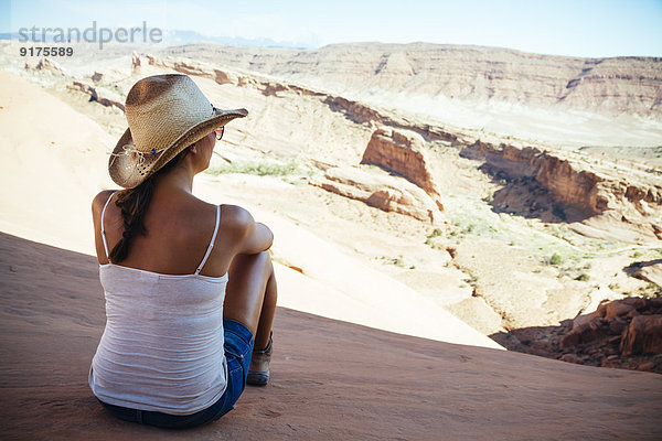 USA  Utah  junge Frau genießt die Aussicht im Arches Nationalpark  Rückansicht
