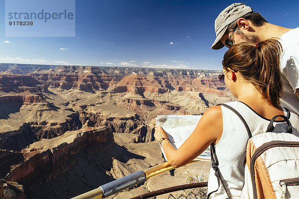 USA  Arizona  Paar mit Kartenausrichtung vor dem Grand Canyon