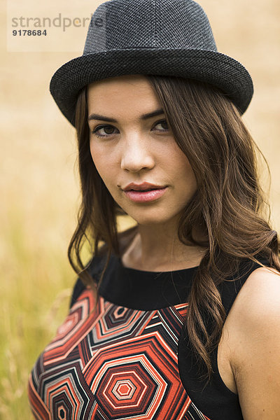 Porträt einer jungen Frau mit schwarzem Hut