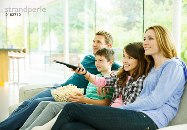 Familie beim Fernsehen im Wohnzimmer