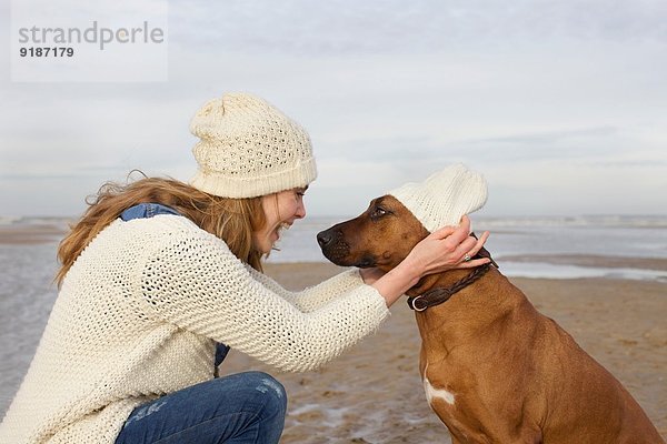 Porträt einer erwachsenen Frau und eines Hundes am Strand  Bloemendaal aan Zee  Niederlande