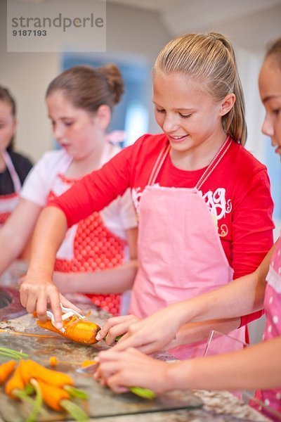 Teenager-Mädchen bereiten Karotten in der Küche vor