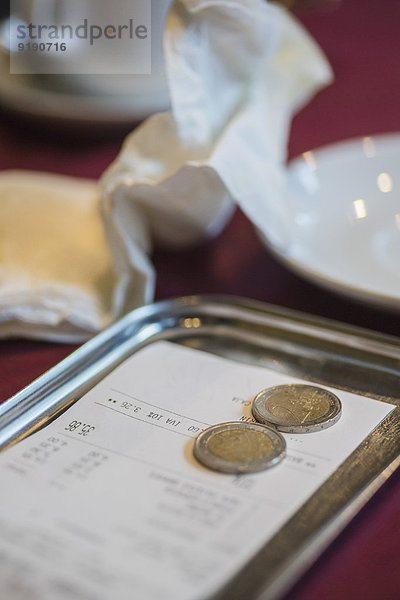 Rechnung und Trinkgeld im Teller auf dem Restauranttisch