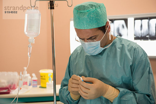 Chirurg bei der Untersuchung medizinischer Geräte in einem Operationssaal