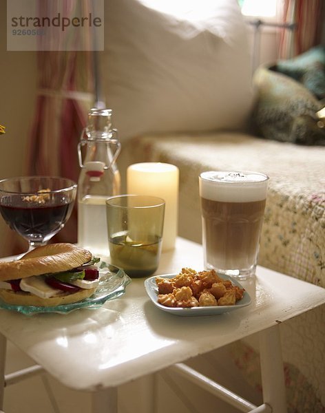 Herbstfrühstück mit Bagel  Mandelplätzchen  Heidelbeersuppe und Kaffee im Schlafzimmer