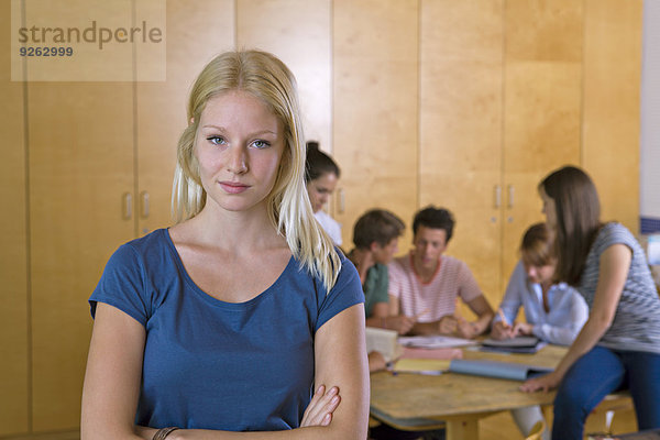 Deutschland  Baden-Württemberg  Portrait einer jungen Studentin und ihrer Mitschülerinnen im Hintergrund