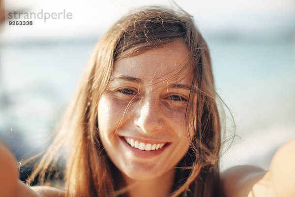 Indonesien  Gili Inseln  Portrait einer glücklichen Frau am Strand
