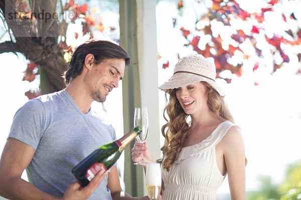 Paare trinken Champagner in der Gartenweinbar