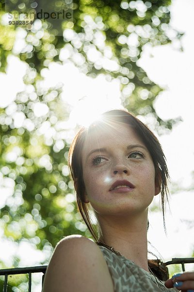 Porträt einer ruhigen jungen Frau im Park