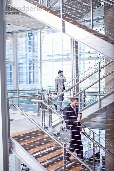 Zwei junge Geschäftsleute auf der Treppe des Konferenzzentrums