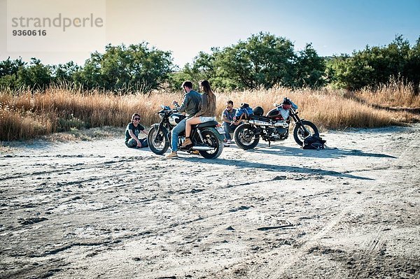 Vier Motorradfreunde machen eine Pause auf der trockenen Ebene  Cagliari  Sardinien  Italien
