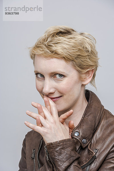 Porträt einer lächelnden Frau mit blonden kurzen Haaren