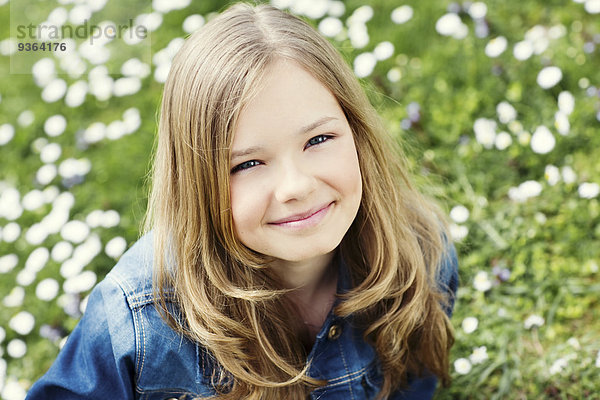 Porträt des lächelnden Mädchens auf Blumenwiese