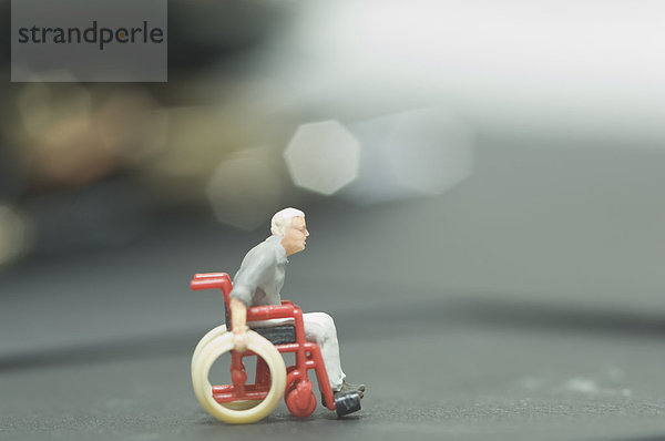 Miniatur-Figur im Rollstuhl