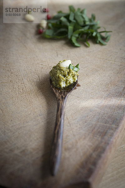 Bärlauch-Pesto und Pinienkern auf einem Holzlöffel