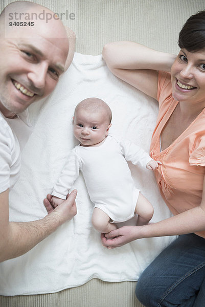 Portrait of parents with baby boy  smiling
