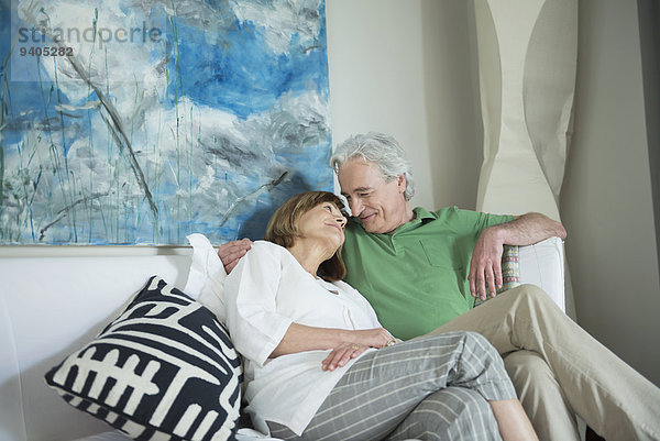 Couple relaxing on couch  smiling