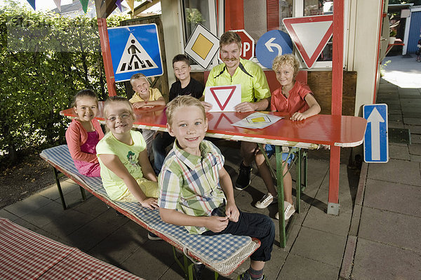 Children and young man at driver training area