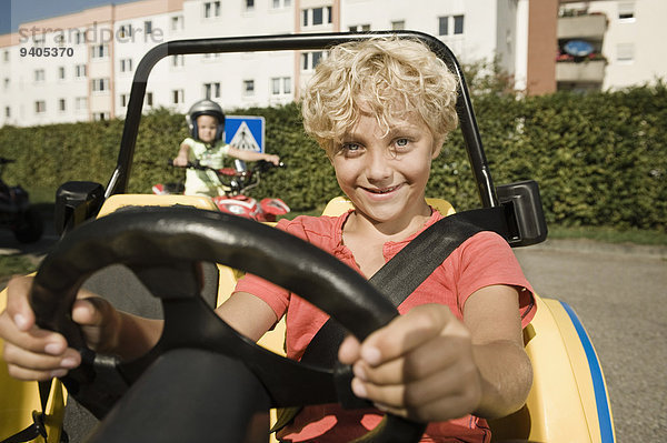 Smiling boy in vehicle on driver training area