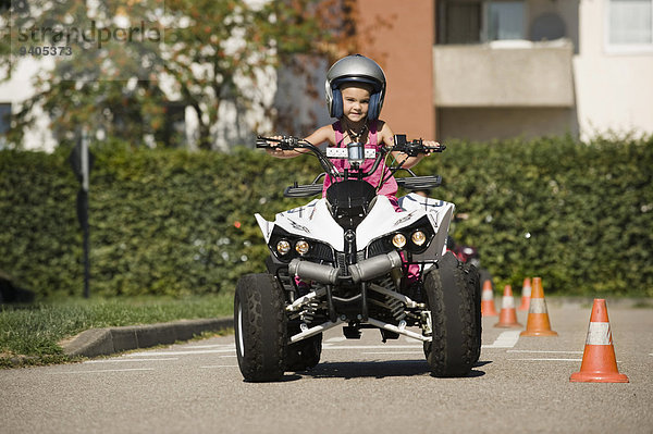 Girl with quadbike on driver training area