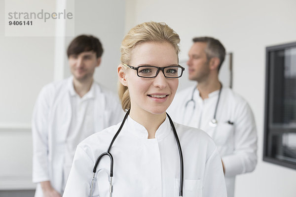 Female doctor  colleagues in background